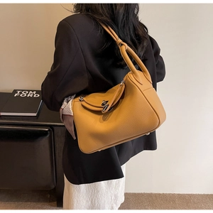 Caramel lychee leather shoulder bag shown on model for elegant daily styling
