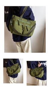 Detail of army green nylon tote bag featuring three front zip pockets and woven pullers