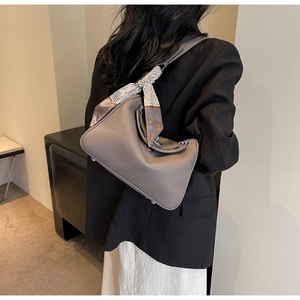 Detail of grey pebbled leather Boston bag with geometric scarf and metal feet