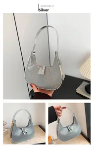 Detailed view of silver crescent moon bag with sparkling rhinestones and metal zipper