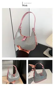 Detail view of pink crescent hobo bag with silver rhinestones and smooth handle