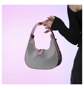 Close-up of sparkling silver rhinestones and pink mirror finish handle on moon bag