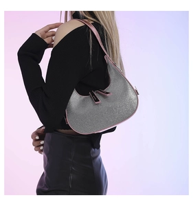 Detail of silver rhinestone crescent bag with pink leather trim and silver zipper