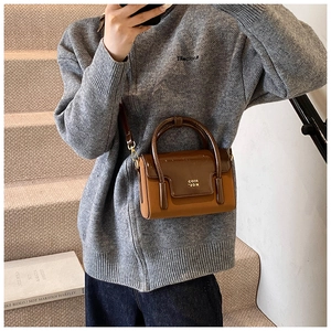 Chic brown patchwork square crossbody bag shown with a grey knit cardigan in a lifestyle setting