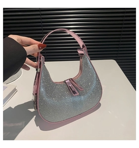 Detail shot of shimmering silver rhinestones and pink metallic leather on a hobo bag