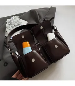 Detail der dunkelbraunen Leder-Umhängetasche mit zwei magnetischen Vordertaschen