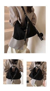 Detail view of the versatile black matte tote bag with adjustable straps and gold buckles
