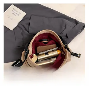 Interior view of khaki canvas tote bag with burgundy lining and spacious capacity