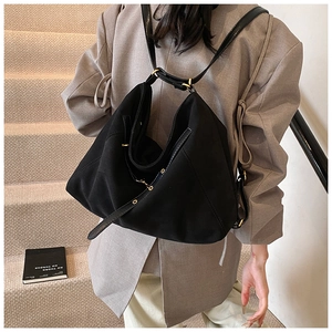 Detail of black matte dual-use tote bag with gold hardware and folded design