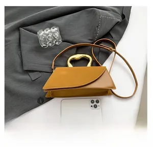 Chic leather square handbag with golden metal handle and adjustable crossbody strap