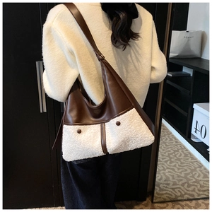 Detail of winter Hobo bag featuring brown PU leather and white plush shearling texture