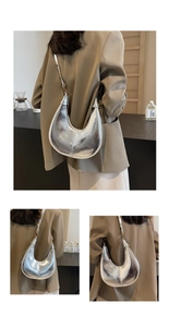Detail of silver metallic crescent bag showing its wrinkled texture and adjustable strap