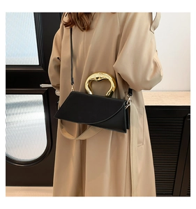 Chic black asymmetrical square bag with gold heart handle and beige fabric strap