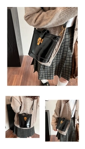 Détail du sac seau en cuir noir brillant avec fermoir métallique doré et bandoulière