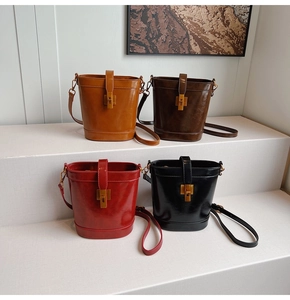Détails de quatre sacs seaux en caramel, marron, rouge et noir avec des fermoirs métalliques