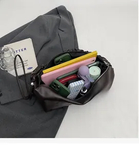 Deep brown dumpling bucket bag showing large interior capacity with daily essentials