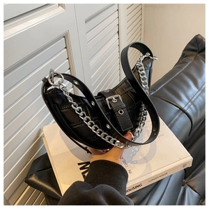 Detail of black crocodile texture hobo bag with bold silver chain and adjustable strap
