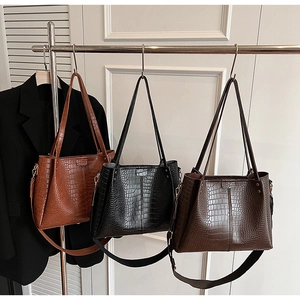 Detailed view of crocodile pattern tote bags in brown, black, and coffee colors