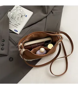Interior view showing the spacious storage capacity of the brown faux fur shoulder bag