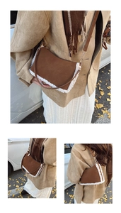 Detail of caramel suede crossbody bag with fleece trim and golden metal buckle