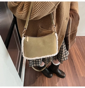 Detail of vintage matte shoulder bag featuring soft white fleece trim and gold hardware