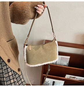 Detail of khaki suede shoulder bag featuring soft white faux shearling trim and gold zipper