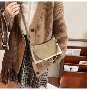 Detail of khaki suede shoulder bag with white faux fur trim and adjustable strap