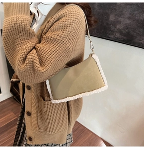 Detail of khaki shoulder bag with white fleece trim and matte leather texture on model