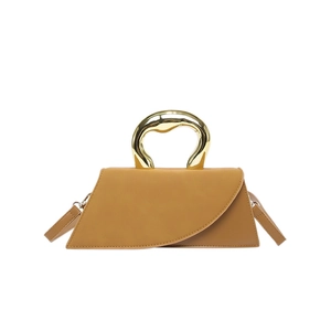 Chic tan crossbody bag with sculptural gold metal handle on a clean white background