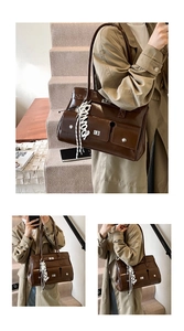 Detail of vintage brown leather satchel with silver buckles and a stylish silk scarf charm
