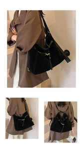 Detail of adjustable black suede tote showing versatile shoulder and backpack straps