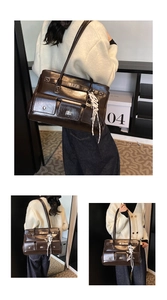 Detail of dark brown leather tote bag showing metallic twist lock and woven strap accessory