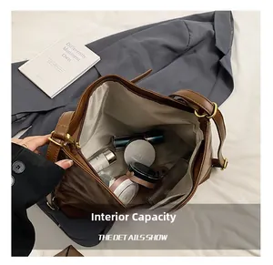 Top view of spacious interior of brown suede tote bag filled with cosmetics and essentials