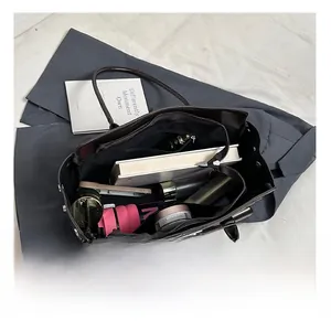 Internal view of large dark brown tote bag showing spacious capacity for daily items