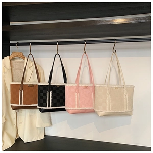 Detail of checkered embossed leather tote bags with plush fleece trim in four colors