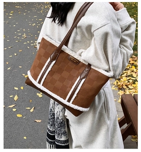 Detailed texture of brown embossed leather tote bag with white plush fleece trimming