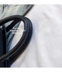 Macro view of black litchi grain leather texture and sturdy reinforced handle stitching