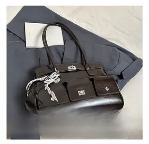 Close-up of dark brown leather satchel featuring multi-pocket design and silver hardware