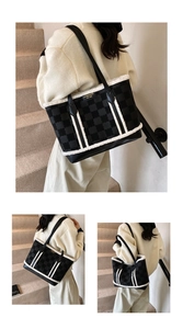 Detail of wool tote bag featuring black checkerboard pattern and plush white faux fur trim