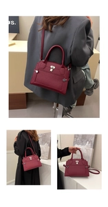 Detail of burgundy pebbled leather tote bag with silver lock and styling options