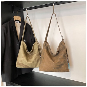 Detail of adjustable strap and silver metal buckle on washed canvas hobo tote bag