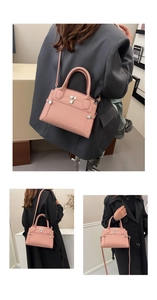 Macro view of pink pebbled leather handbag with silver twist lock and handle detail
