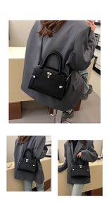 Close-up of black lychee grain leather handbag with silver lock and shoulder strap detail
