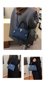 Detail of navy leather handbag featuring a metal lock and detachable shoulder strap
