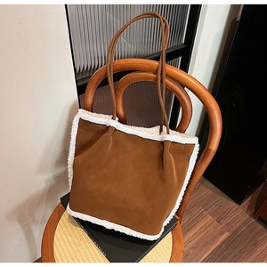 Brown suede tote bag featuring white faux fur trim on a vintage wooden chair