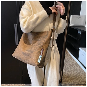 Detail of dark brown vintage texture canvas tote bag with wide strap and branded labels
