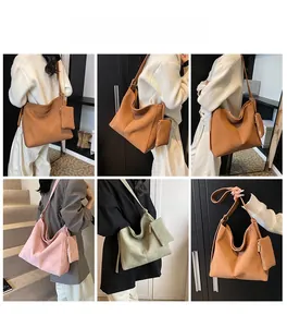 Detail of minimalist Hobo shoulder bag with matching pouch in various autumn colors