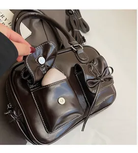 Detail view of dark coffee functional pockets and magnetic closure on vintage handbag