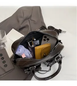 Top view of spacious interior storage in a brown faux leather baguette bag with daily items