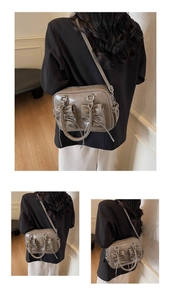 Detail of gray glossy underarm bag with decorative bow pockets and shiny finish